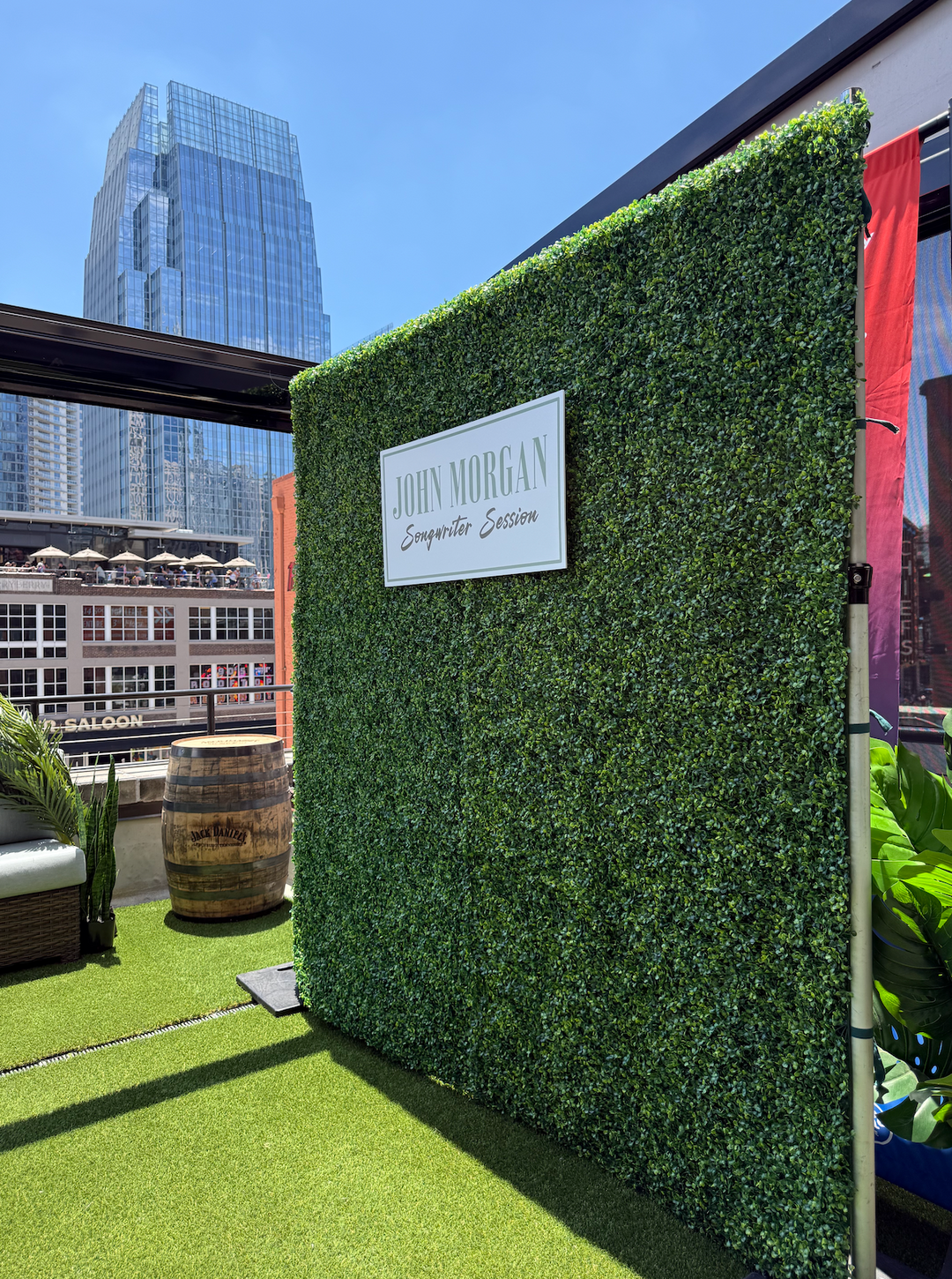 A tall artificial green boxwood grass wall backdrop that&