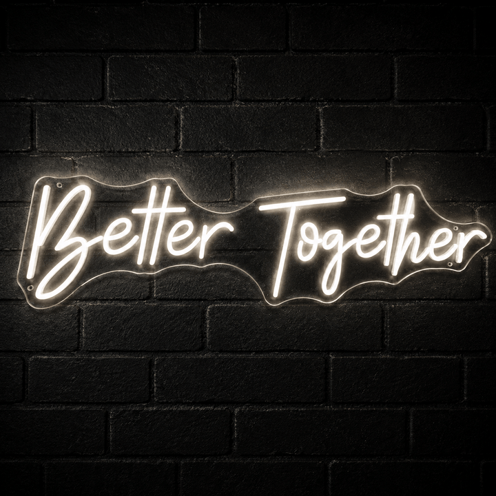 Better Together LED neon sign in warm white mounted on a dark black brick wall
