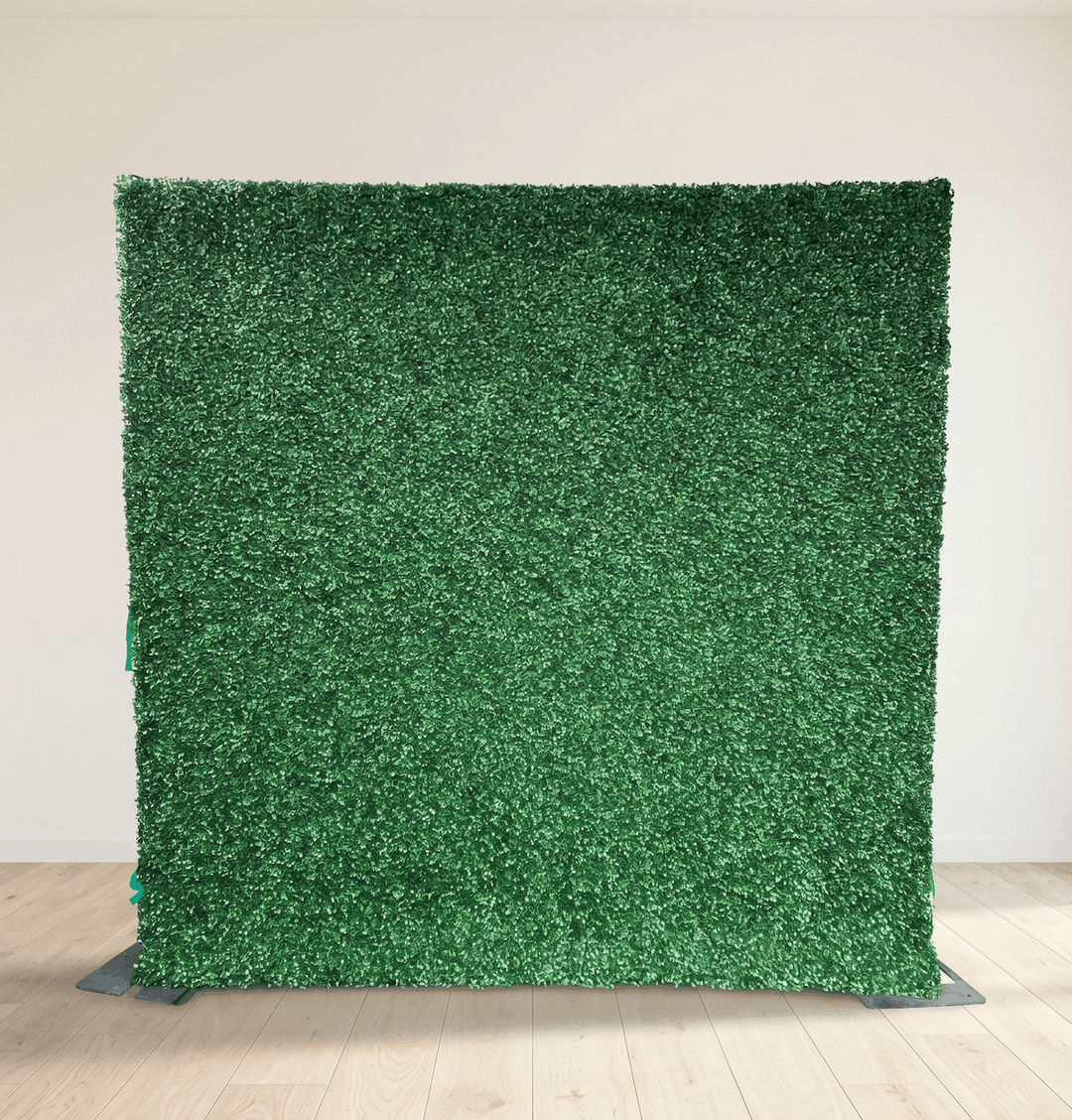 Artificial grass panel for sale on a stand against a plain wall