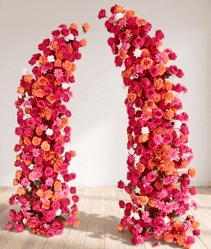 Two floral arches made of hot pink, orange, and red flowers for sale on a white background.