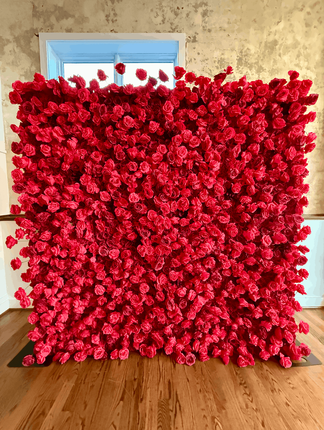 Full view of the Leigh 8x8ft 3D silk red rose flower wall backdrop installed indoors