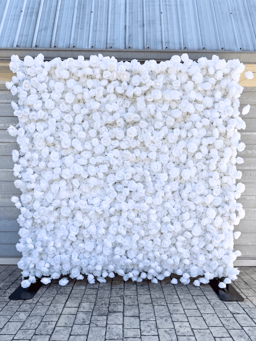 Full 8x8 freestanding Lilli white rose silk flower wall backdrop with weighted professional bases and outdoor-ready canvas backing for wedding and event rentals.