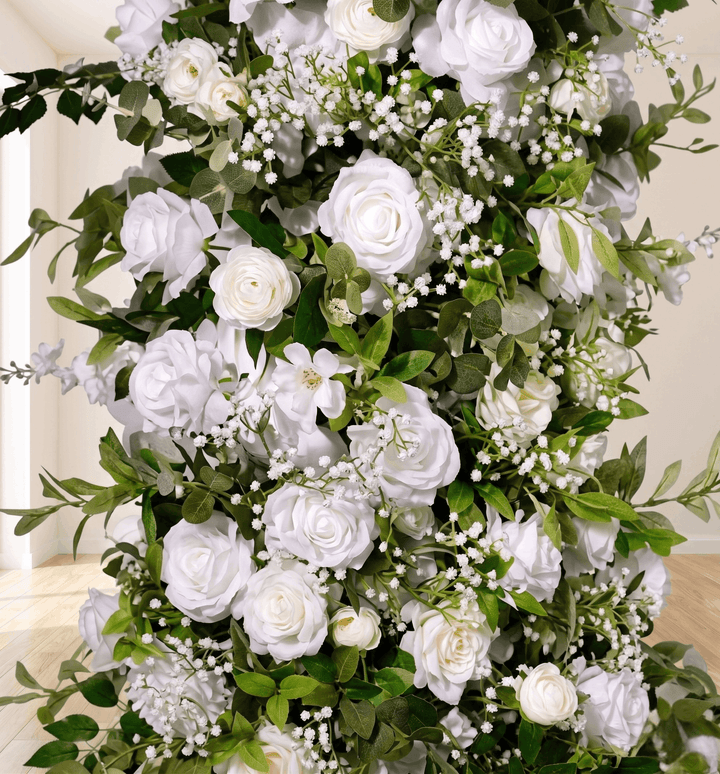 A large artificial floral arrangement featuring white roses, white baby&