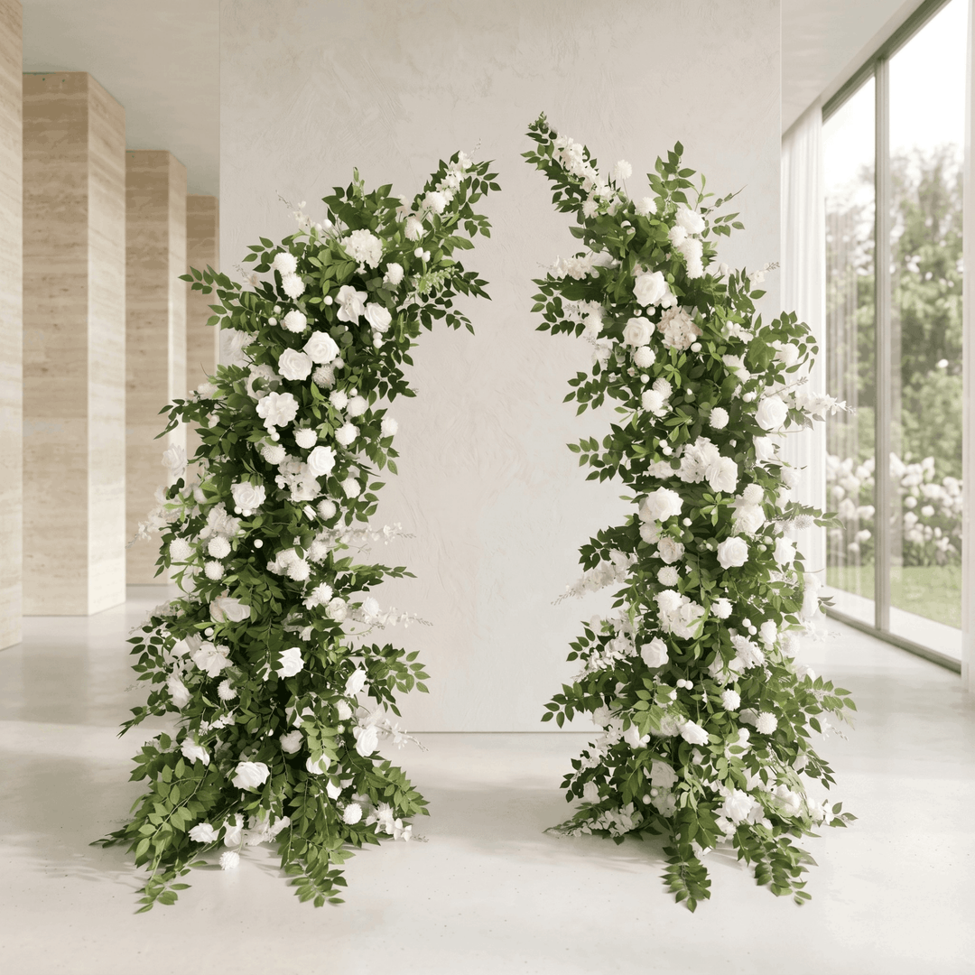 Two floral arches decorated with white flowers and greenery in a modern indoor setting.